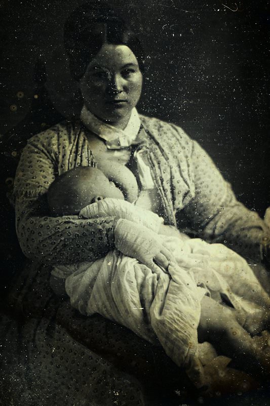 Unidentified woman breastfeeding a baby, ca. 1860 
